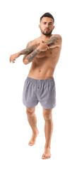 Handsome young man in underwear on white background