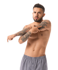 Handsome young man in underwear on white background