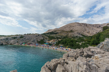 Fototapeta na wymiar Beach at adriatic sea with karst rocky landscape and mountain on Krk island, Croatia