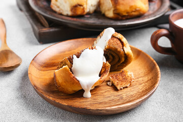 Plate of tasty cinnamon roll on white background