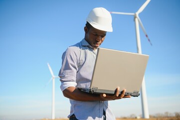 Engineer African man standing with wind turbine