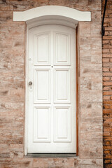 Fototapeta na wymiar Old white door and stone wall. 