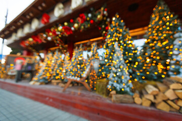 New Year's or Christmas decoration street cafe with light bulbs and trees. Christmas background