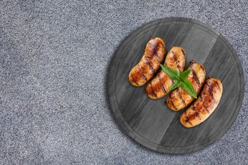 A plate of fried sausages with garlic and basil