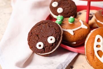 Dessert stand with funny cookies on table