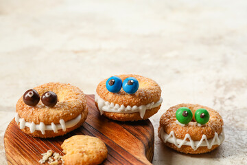 Board with funny cookies on grunge background
