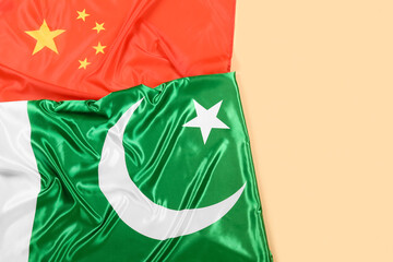 Flags of China and Pakistan on color background, top view