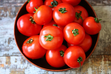 Fresh juicy red tomatoes in a bowl.