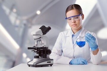 Biotechnologist scientist researching with a microscope in pharma lab. Modern laboratory