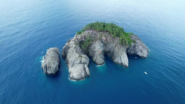 Aerial view around the Ilheu de Santana island, on Gulf of Guinea, near Sao Tome - orbit, drone shot