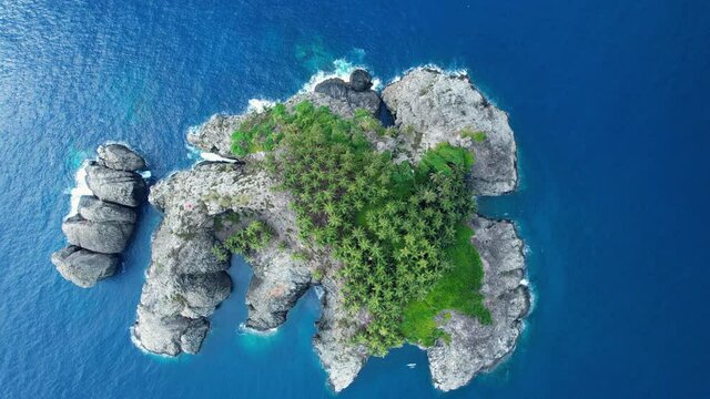 Aerial view above the Ilheu Santana isle, in Sao Tome, Africa - top down, drone shot