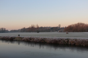 Fototapeta na wymiar Sunrise over the frost covered Meads outside Hertford, UK