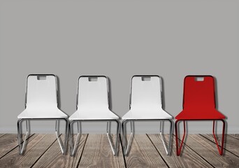 Three vacant white chairs and one red in office or room. Job recruiting, leadership and business due covid-19 virus