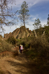 Obraz premium 2 senior women walk together at pinnacles national, monterey county, california, u.s.a. 
