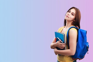 Happy female student holding college materials and wearing a backpack,