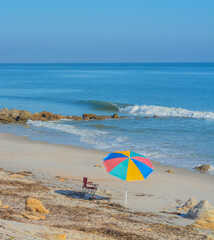 Fototapeta na wymiar A Umbrella on the beach of the Atlantic Ocean, at Marineland Beach in Marineland, Flagler County, Florida