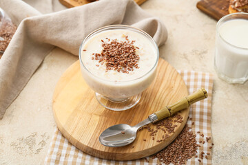 Tasty dessert with flax seeds and yoghurt in glass on table - obrazy, fototapety, plakaty