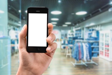 Online shopping concept. Hands holding mobile phone on blurred store as background