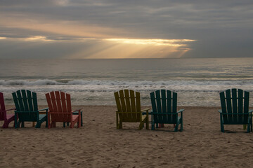 colorful beach chairs by the sea in the morning