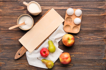Fresh dough and ingredients for apple strudel on wooden background