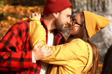 Happy loving couple hugging on sunny autumn day