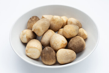 Straw mushroom in white bowl on white background.