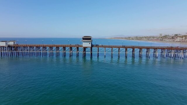 Oceanside Pier in south California. longest wooden pier on western United States coastline at 1,954 feet. Panning aerial
