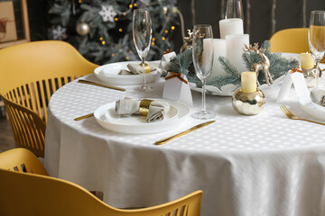 Dining table with setting for Christmas celebration indoors