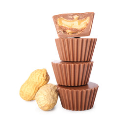 Tasty peanut butter cups on white background