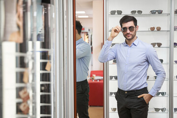 Caucasian man staring ahead while wearing sunglasses