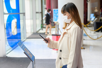 Bangkok ; Thailand: 20/10/2021 - Woman's hand is holding smartphone for checking News about COVID-19 prevention in shopping center..