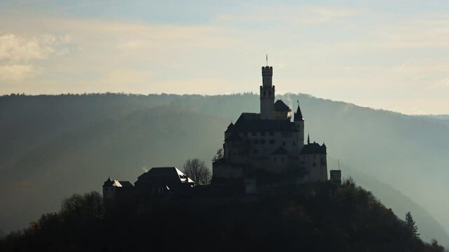 Silhouette time lapse of Marksburg Castle in fog, telephoto shot
