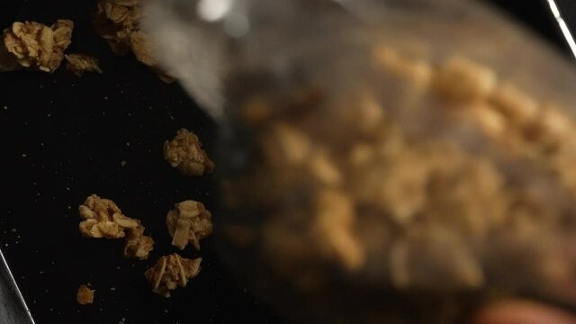 Muesli poured over chocolate, close shot