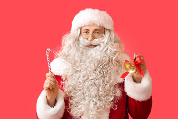 Santa Claus with Christmas bell and candy cane on red background