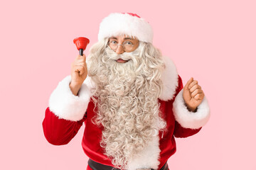 Santa Claus with Christmas bell on pink background