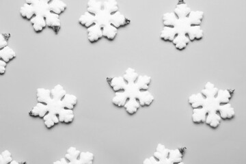Beautiful Christmas decorations in shape of snowflakes on grey background