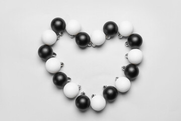 Heart made of beautiful Christmas balls on white background