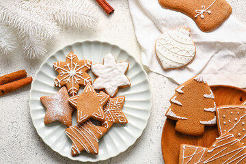 Plates with tasty gingerbread cookies on light background, closeup