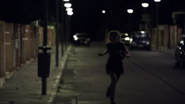 Scared Woman Being Stalked, Running Fast In The Street At Midnight. static