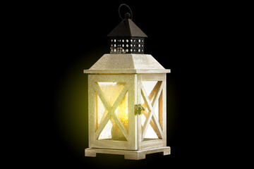 Christmas Lantern on snowy table with festive decoration.