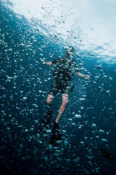 scuba diving in the sea cover with bubbles