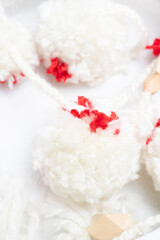 Fluffy white and red pom poms