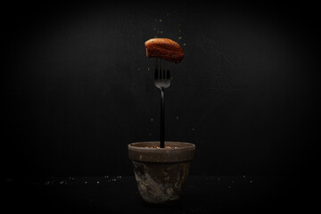 A fork and a piece of meat that's cooked well.