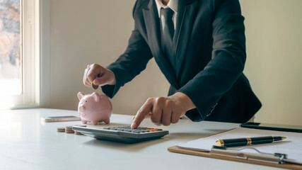 Close-up of women using calculators and note-taking, accounting reports, cost-calculation ideas, and saving money.