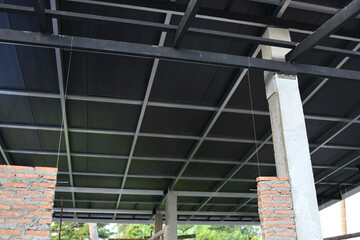 Silver steel structure under the roof of the PU house black foam under construction
