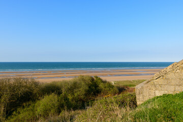 Fototapeta na wymiar The WN62 bunker above Omaha beach in Europe, France, Normandy, towards Arromanches, Colleville, in spring, on a sunny day.