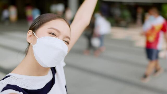 young smiling asian female adult video call selfie with cheerful move around to show the famous place of vacation weekend to her family by smartphone devide happiness travel concept