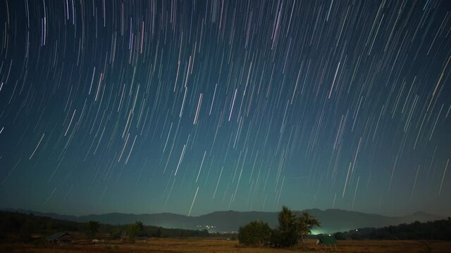 Time-lapse star trails revolving with Geminids meteor shower in the night at Northern Thailand