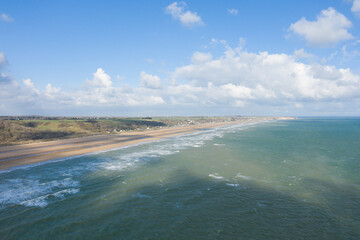 The fine sand beach of Omaha beach in Europe, in France, in Normandy, towards Arromanches, in Colleville, in spring, on a sunny day.