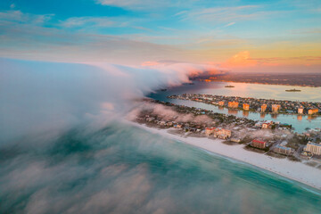 Clearwater Beach Florida. Panorama of City. Summer vacations. Beautiful View on Hotels and Resorts on Island. Turquoise Color of Ocean water. Fog over shore Gulf of Mexico. Aerial photography